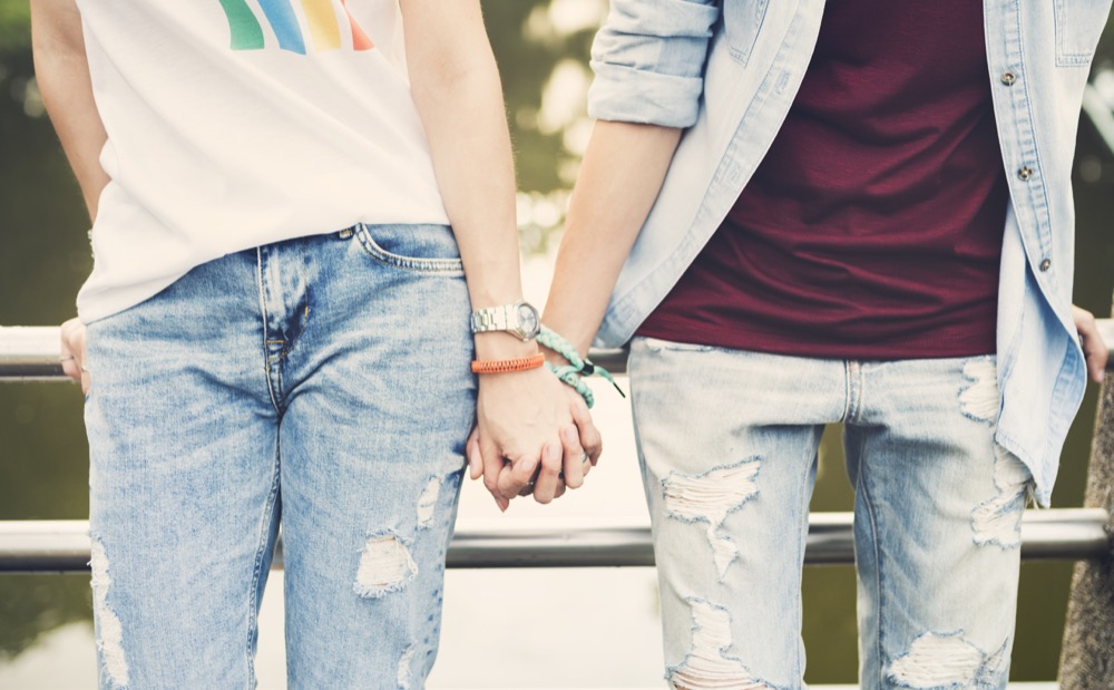 Mother and her teenager holding hands