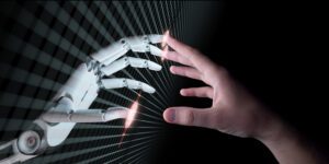hands of an AI robot and human touching
